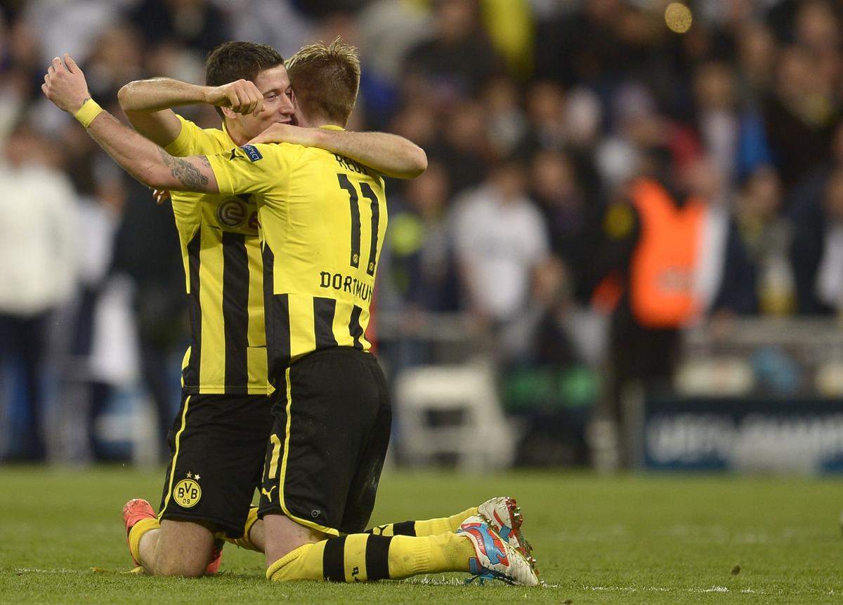 Dortmund’s Robert Lewandowski (L) and Marco Reus celebrate at the end of the UEFA Champions League 2013 semifinal second leg against Real Madrid.