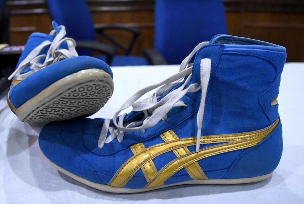 Sakshi Malik’s shoes are seen on the table at the Press Club in New Delhi.