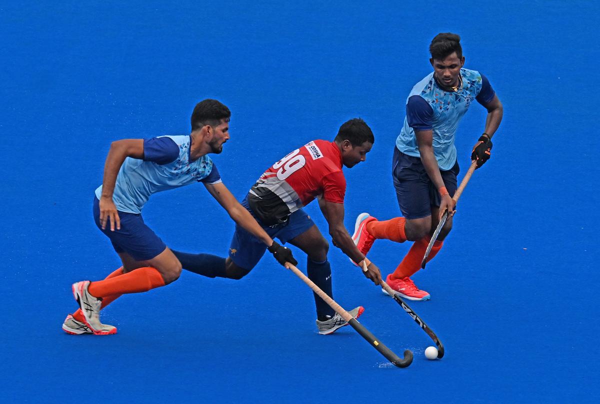 Prasad Kujur (99 Red jersey) of Hockey Association of Odisha in action against Central Secretariat during the 95th All India MCC Murugappa Gold Cup Hockey Tournament 2024 at the Mayor Radhakrishnan Stadium, Egmore in Chennai on Thursday. 