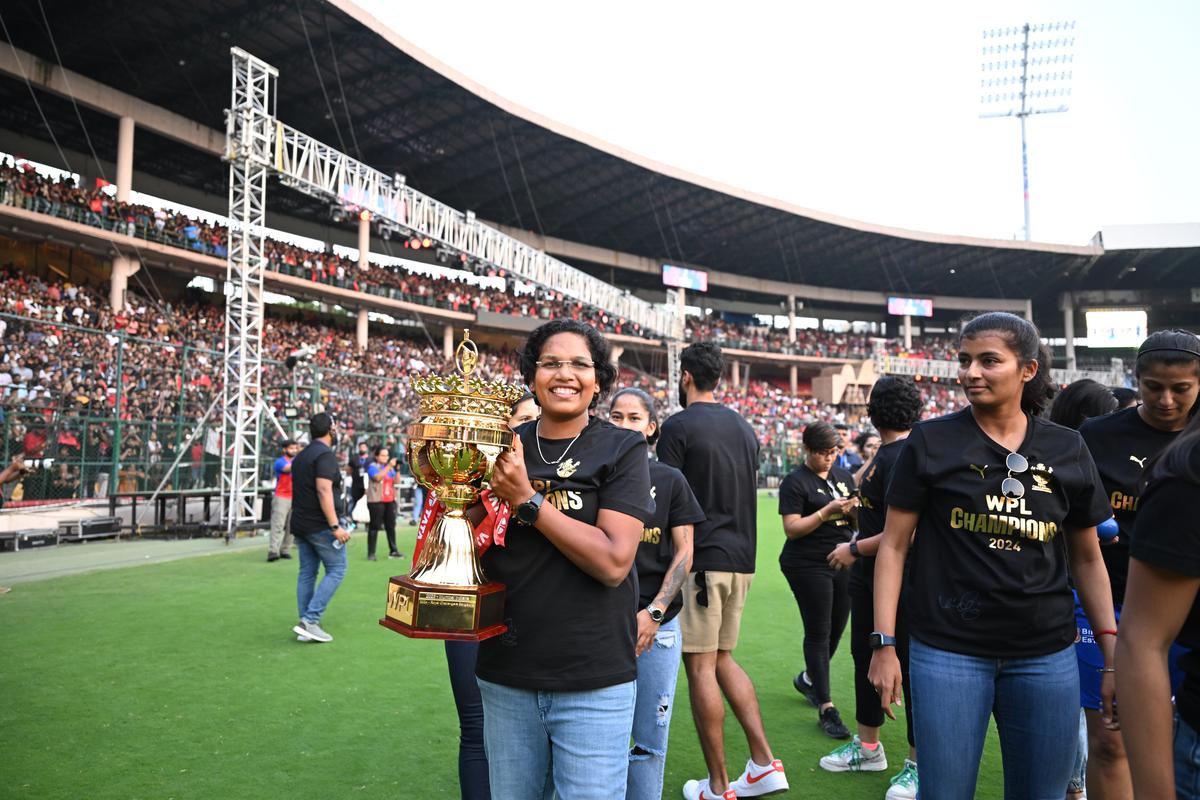 Asha Shobana celebrates after winning the WPL 2024 title with RCB. 