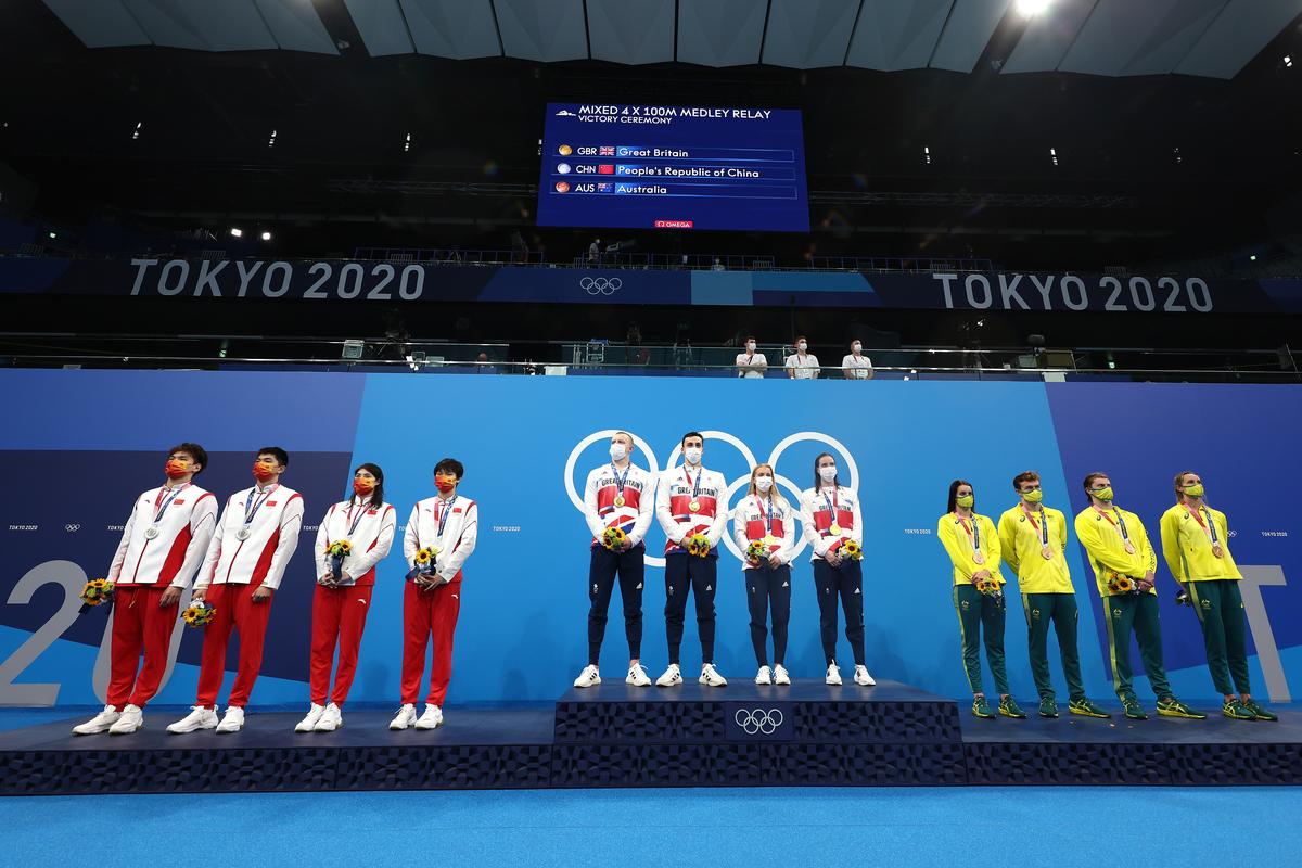 (L-R) Silver medalists Jiayu Xu, Zibei Yan, Yufei Zhang and Junxuan Yang of Team China, Gold medalists Adam Peaty, James Guy, Anna Hopkin and Kathleen Dawson of Team Great Britain, Bronze medalists Kaylee McKeown, Zac Stubblety-Cook, Matthew Temple and Emma McKeon of Team Australia pose on the podium during the medal ceremony for the Mixed 4 x 100m Medley Relay final.