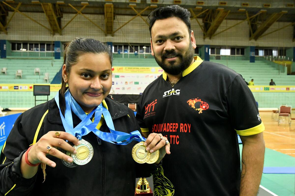 A winning combo: Sutirtha Mukherjee poses with her medals from the 81st senior national and interstate championship in Hyderabad on February 2, 2020. Also seen in the picture, is her coach Soumyadeep Roy.