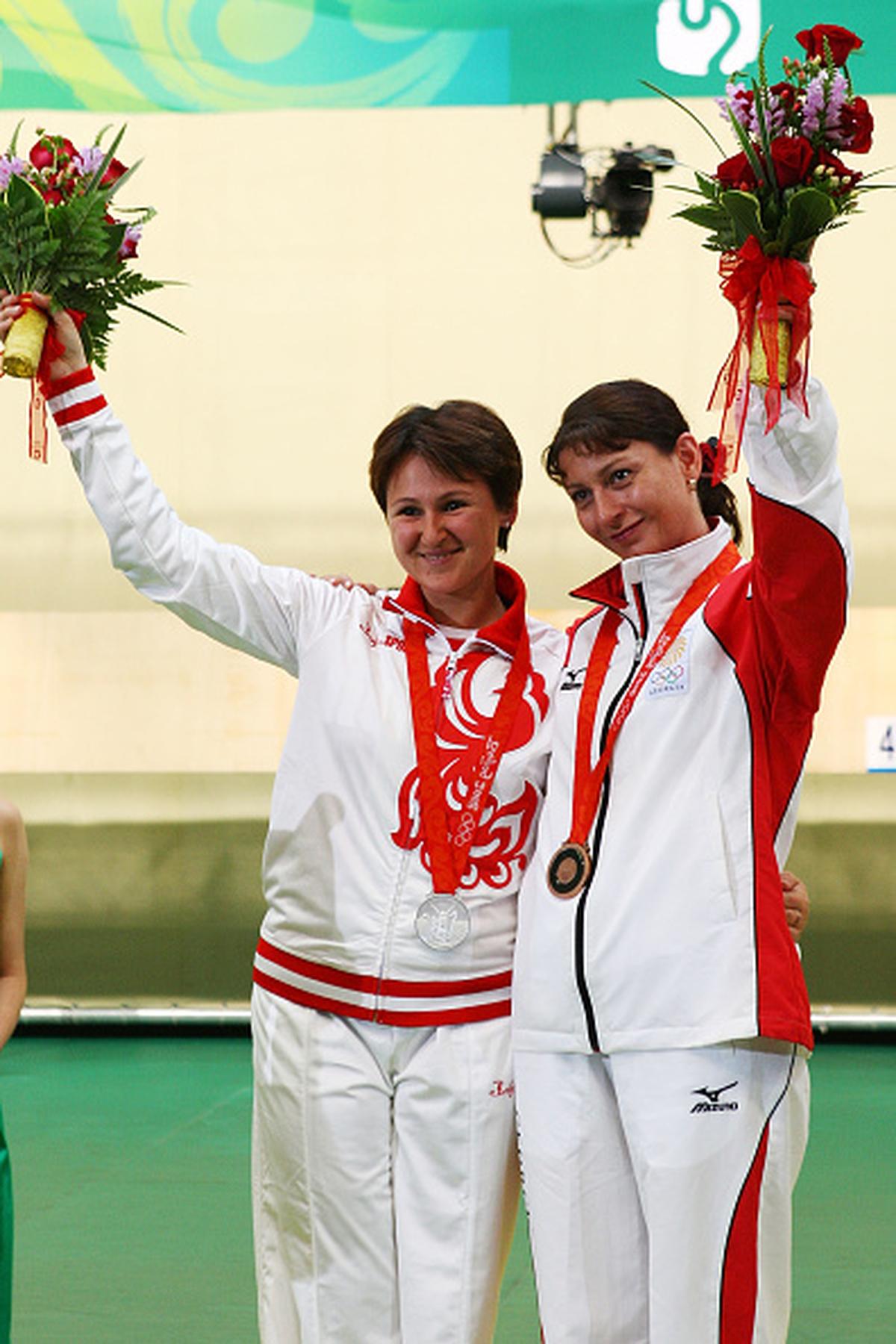 From left to right: Russia’s Natalia Paderina (silver medallist) and Georgia’s Nino Salukvadze (bronze medallist) celebrate after the women’s 10m air pistol final at Beijing Olympics on August 10, 2008.