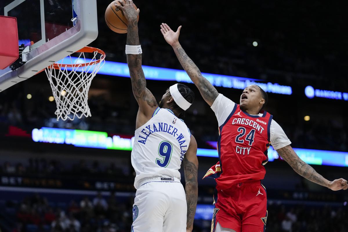 Minnesota Timberwolves guard Nickeil Alexander-Walker (9) goes to the basket against New Orleans Pelicans guard Jordan Hawkins (24) in the second half of an NBA basketball game in New Orleans.