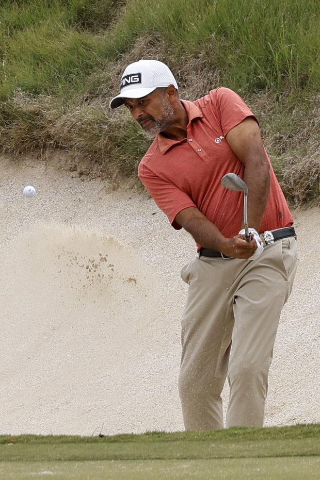 Arjun Atwal, of India, hits out of a bunker on the 18th hole during the first round of the Senior PGA Championship golf tournament at Fields Ranch East in Frisco, Texas. 