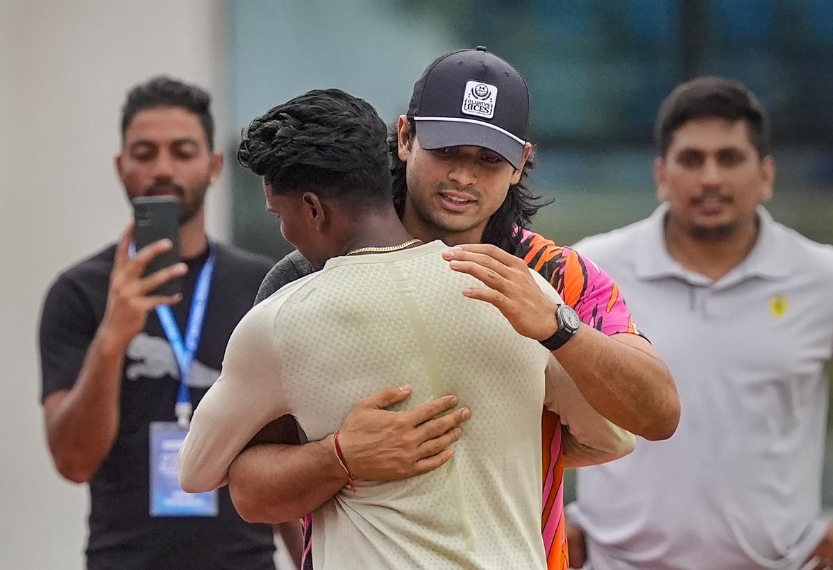 Neeraj Chopra interacts with fellow athletes ahead of the men’s javelin throw event.