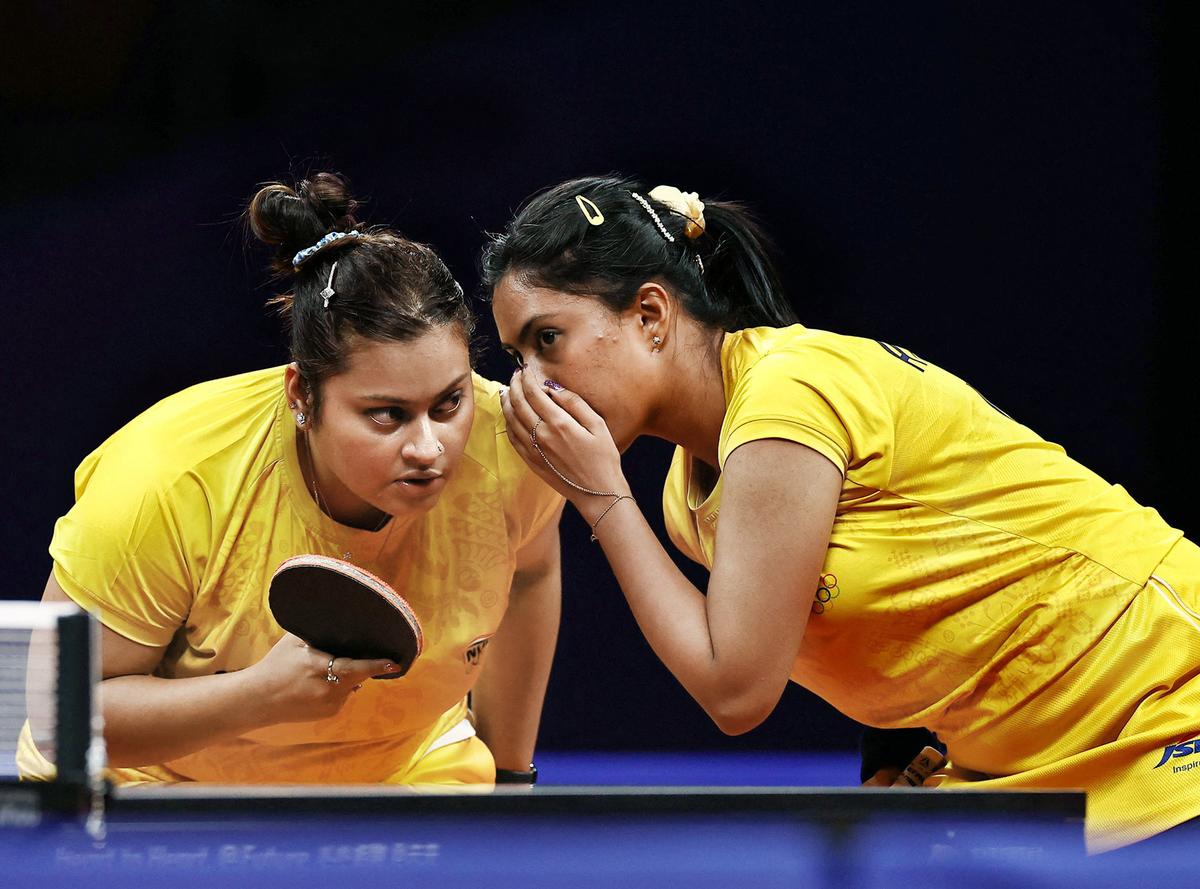 Plotting the line of action: India’s Sutirtha Mukherjee and Ayhika Mukerjee discuss strategies during a women’s doubles semifinal match.