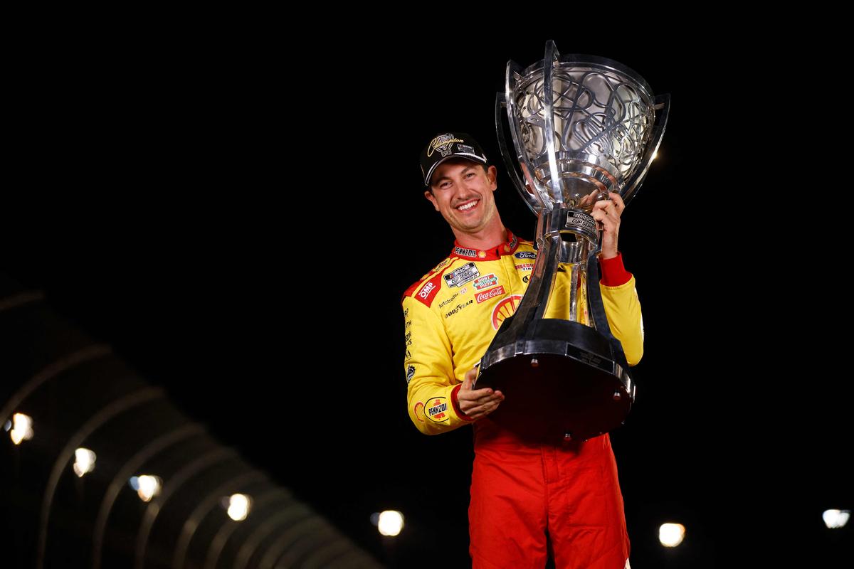 Joey Logano, poses for a photo after winning the NASCAR Cup Series Championship Race at Phoenix Raceway in Avondale, Arizona.