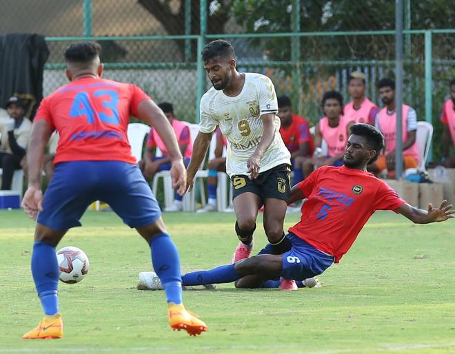  Golden Threads’ defender P.K. Faseen (right, No. 6) attempts to stop FC Bengaluru United’s forward Vinil Poojary (No. 9) in the Second Division I-League match in Kochi on Monday.