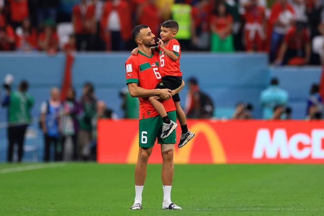Romain Saiss of Morocco interacts with his son after the FIFA World Cup Qatar 2022 semi final match between France and Morocco at Al Bayt Stadium.