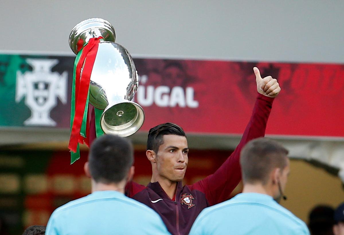 FILE PHOTO: Portugal’s Cristiano Ronaldo holds the Euro 2016 championship trophy before the team’s match against Sweden.  