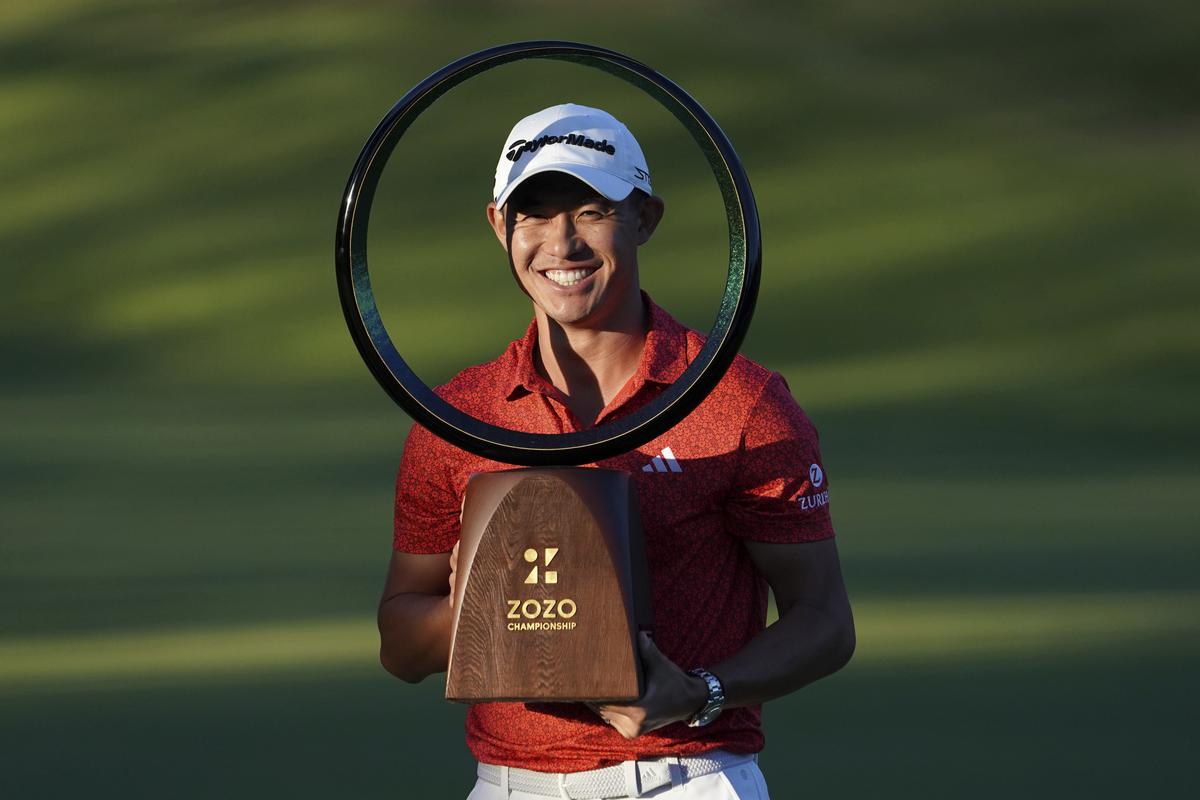Collin Morikawa of the United States poses with the trophy after winning the PGA Tour Zozo Championship at the Narashino Country Club in Inzai on the outskirts of Tokyo, Sunday, Oct. 22, 2023. (AP Photo/Tomohiro Ohsumi)