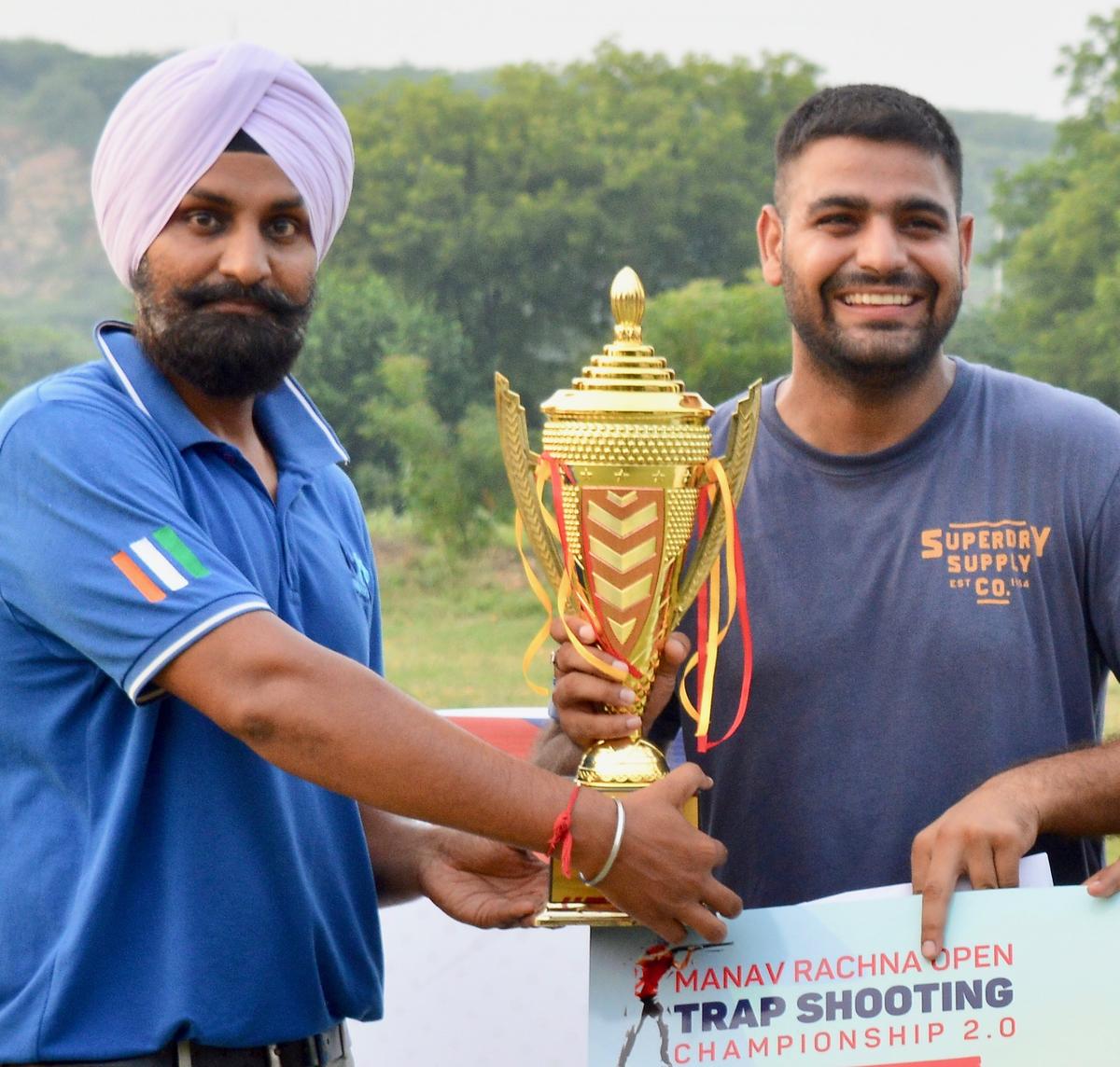 Lakshay Sheoran being presented the trophy after winning the trap event at the Manav Rachna open shotgun championship.