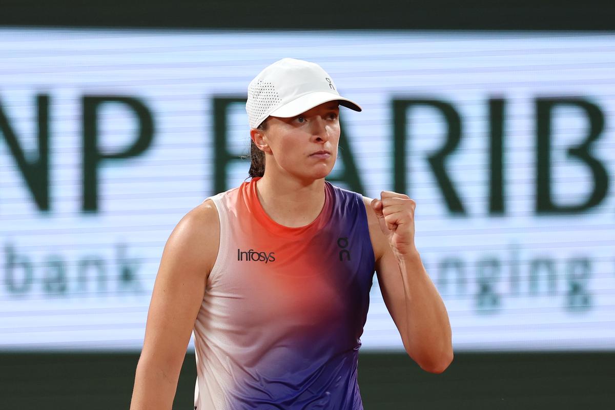 Poland’s Iga Swiatek celebrates after beating Japan’s Naomi Osaka in the second round of French Open at Roland Garros on May 29, 2024.