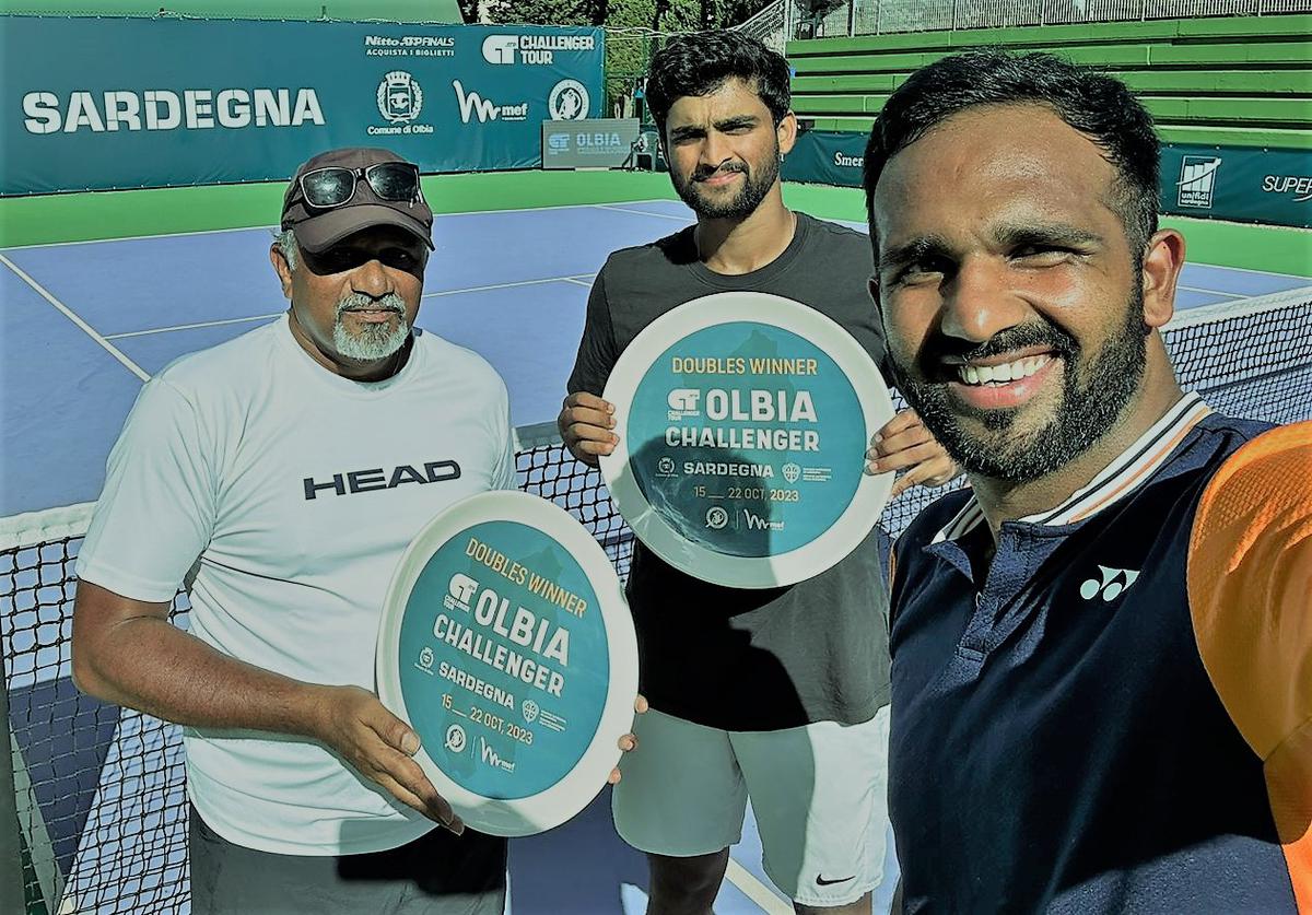 Rithvik Bollipalli and Arjun Kadhe with coach M Balachandran (left) after winning the Challenger title in Olbia, Italy, on Saturday.