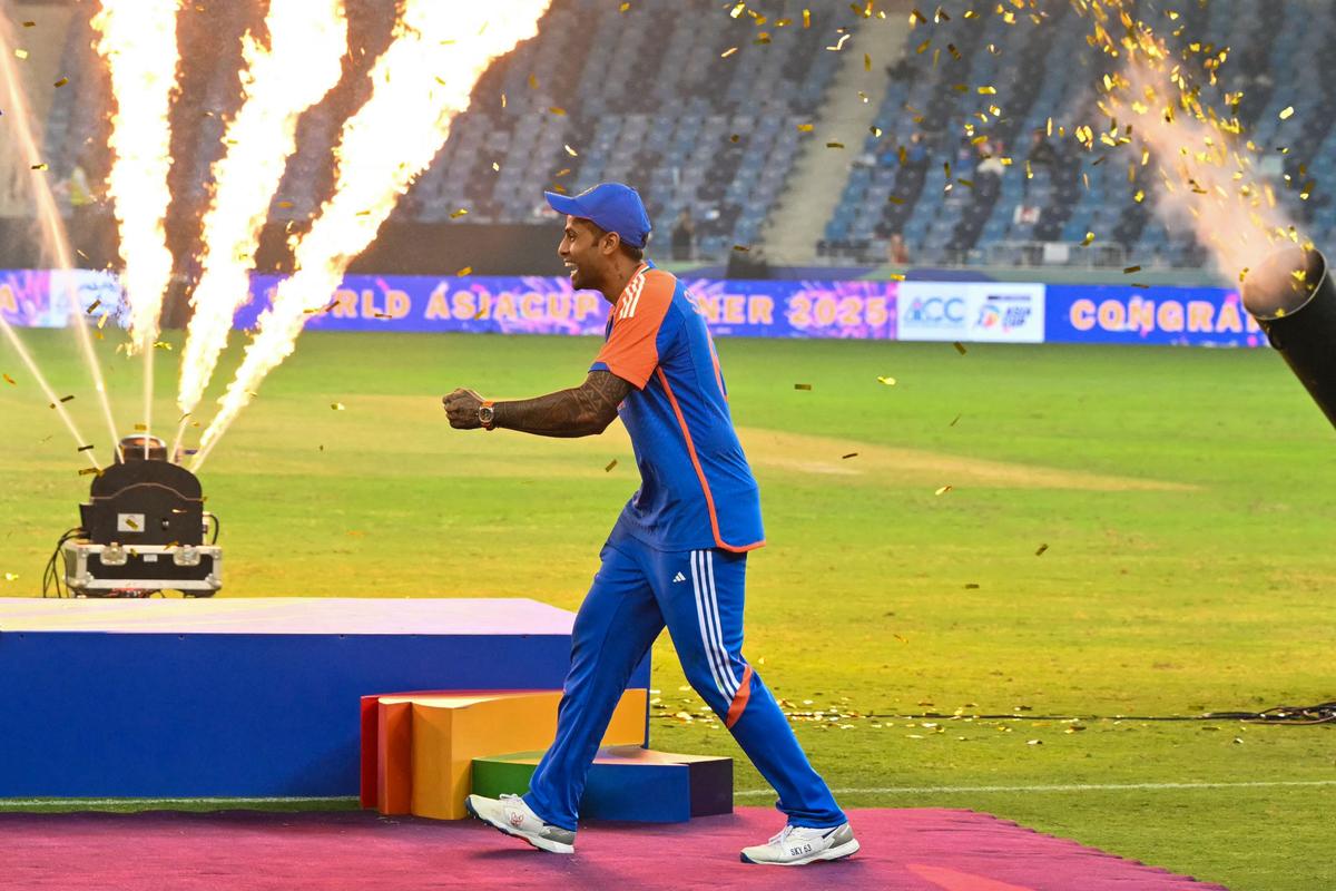 India’s captain Suryakumar Yadav playfully pretends to hold the trophy as his teammates celebrate their victory against Pakistan in the Asia Cup 2025 final.