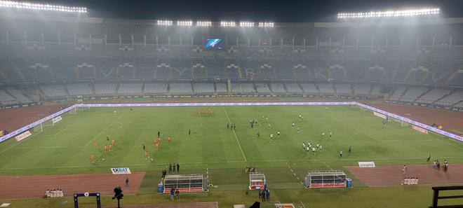 East Bengal and Bengaluru FC players warm up before the start of the match. 
