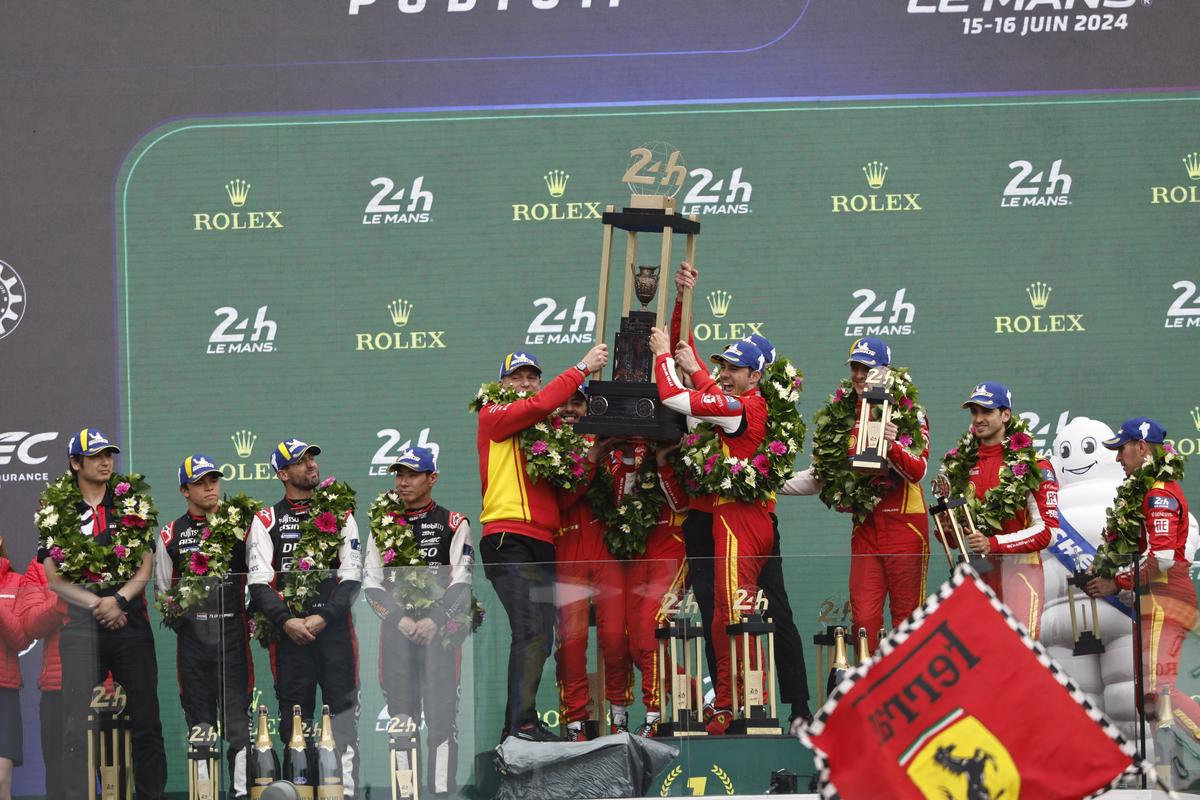 Ferrari 499P Hybrid Hypercar WEC’s team, Spanish driver Miguel Molina, Italian driver Antonio Fuoco, and Danish driver Nicklas Nielsen celebrate on the podium.