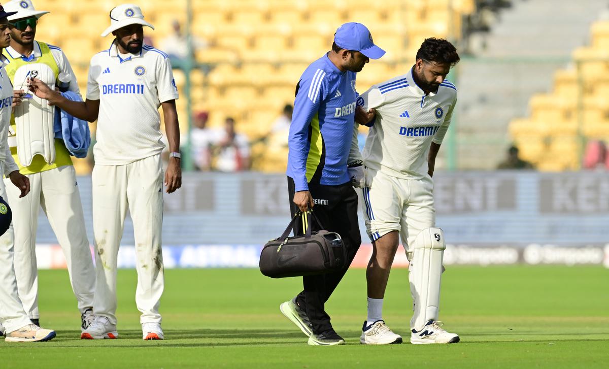 India’s wicketkeeper Rishabh Pant hobbles off.