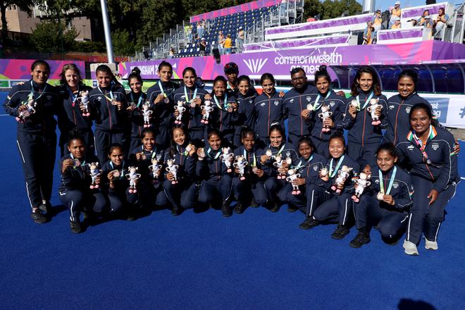 BIRMINGHAM, ENGLAND - AUGUST 07: Bronze Medallists Team India celebrate during the Women's Hockey Medal Ceremony on day ten of the Birmingham 2022 Commonwealth Games at University of Birmingham Hockey & Squash Centre on August 07, 2022 on the Birmingham, England. (Photo by Dean Mouhtaropoulos/Getty Images)