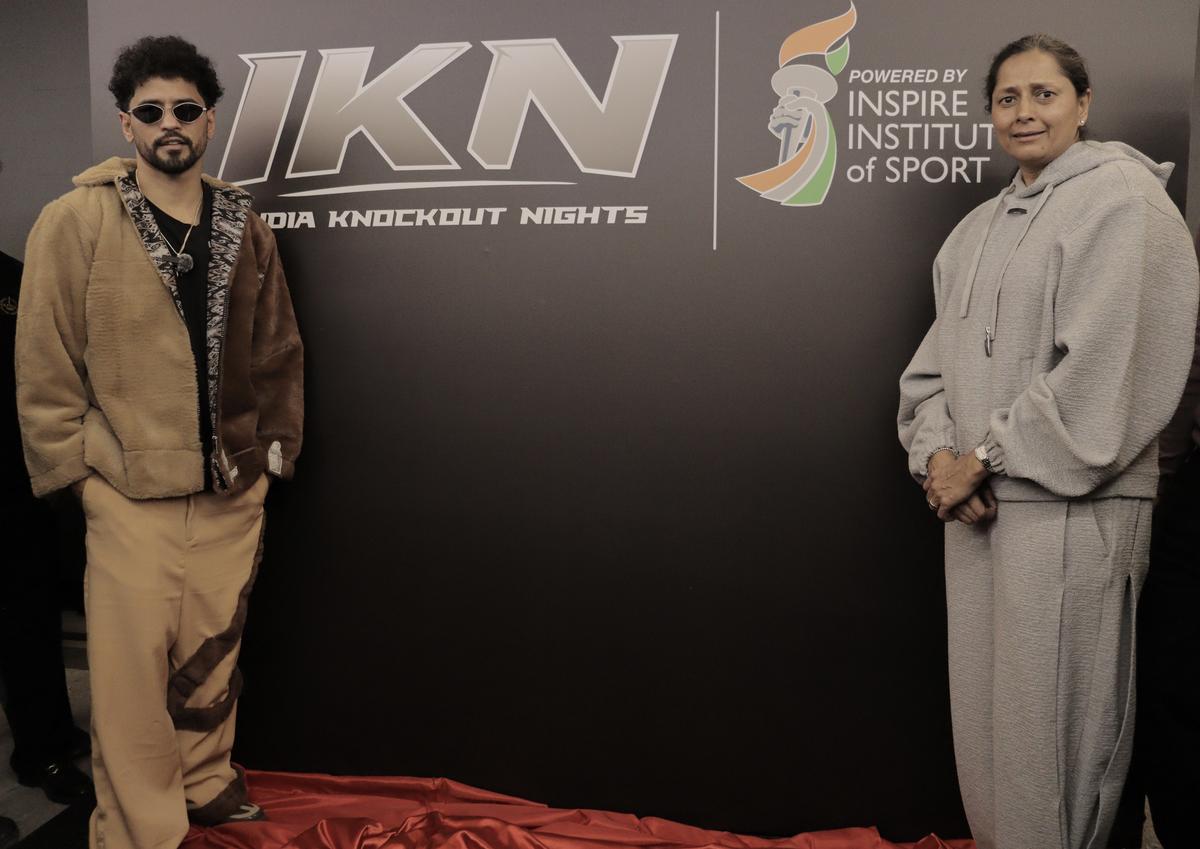 Neeraj Goyat, professional Indian boxer, and IIS president Manisha Malhotra (right) pose for a picture.