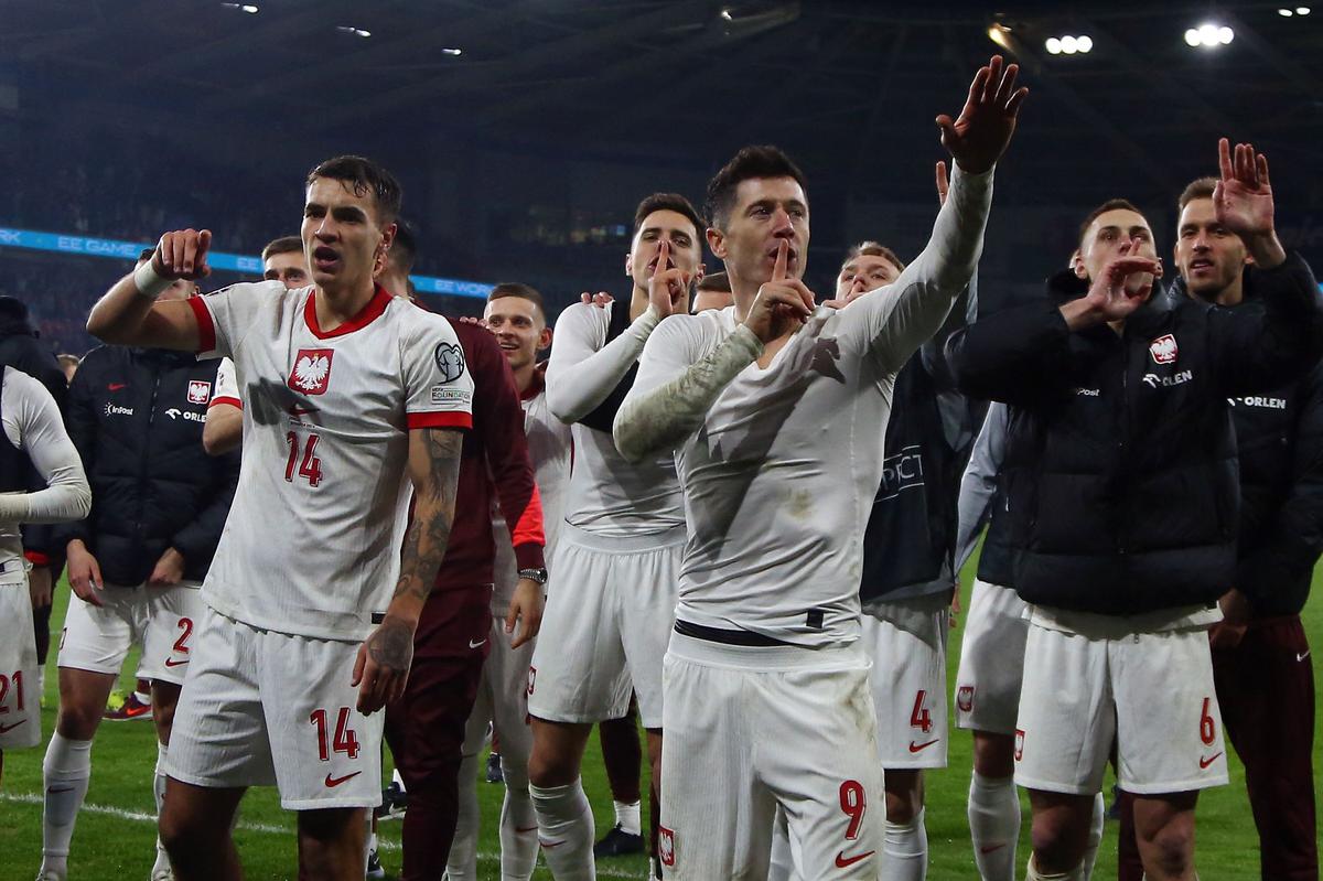 Poland players including Poland’s forward #09 Robert Lewandowski celebrate winning in a penalty shoot out in the UEFA EURO 2024 qualifier play-off final first leg football match between Wales and Poland. 
