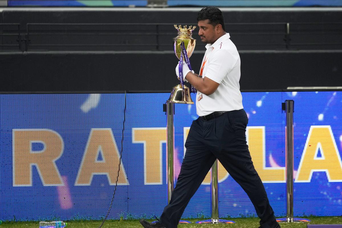 An official removes the  Asia Cup winners’ trophy from the presentation area.
