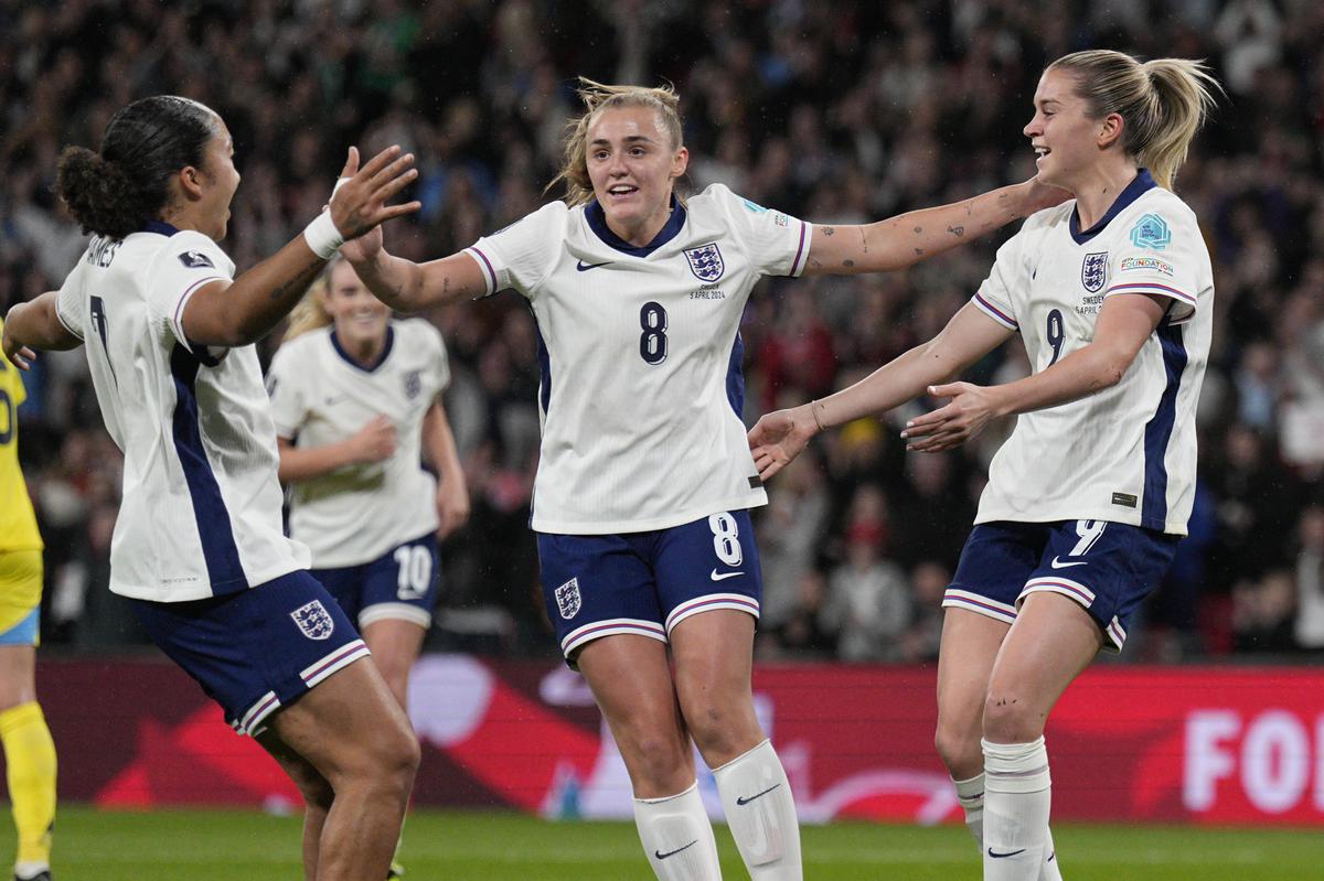 England’s Alessia Russo (right) celebrates with teammates after scoring the opening goal during the Euro 2025 qualifier against Sweden at the Wembley stadium in London on Friday.