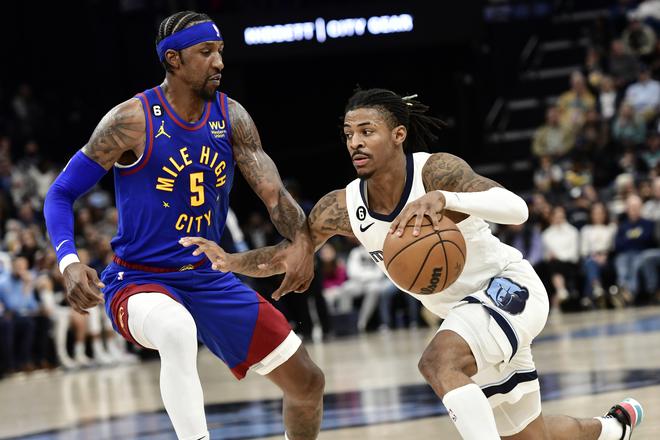 Memphis Grizzlies guard Ja Morant is defended by Denver Nuggets guard Kentavious Caldwell-Pope (5) during the second half of an NBA basketball game Saturday, Feb. 25, 2023, in Memphis. 