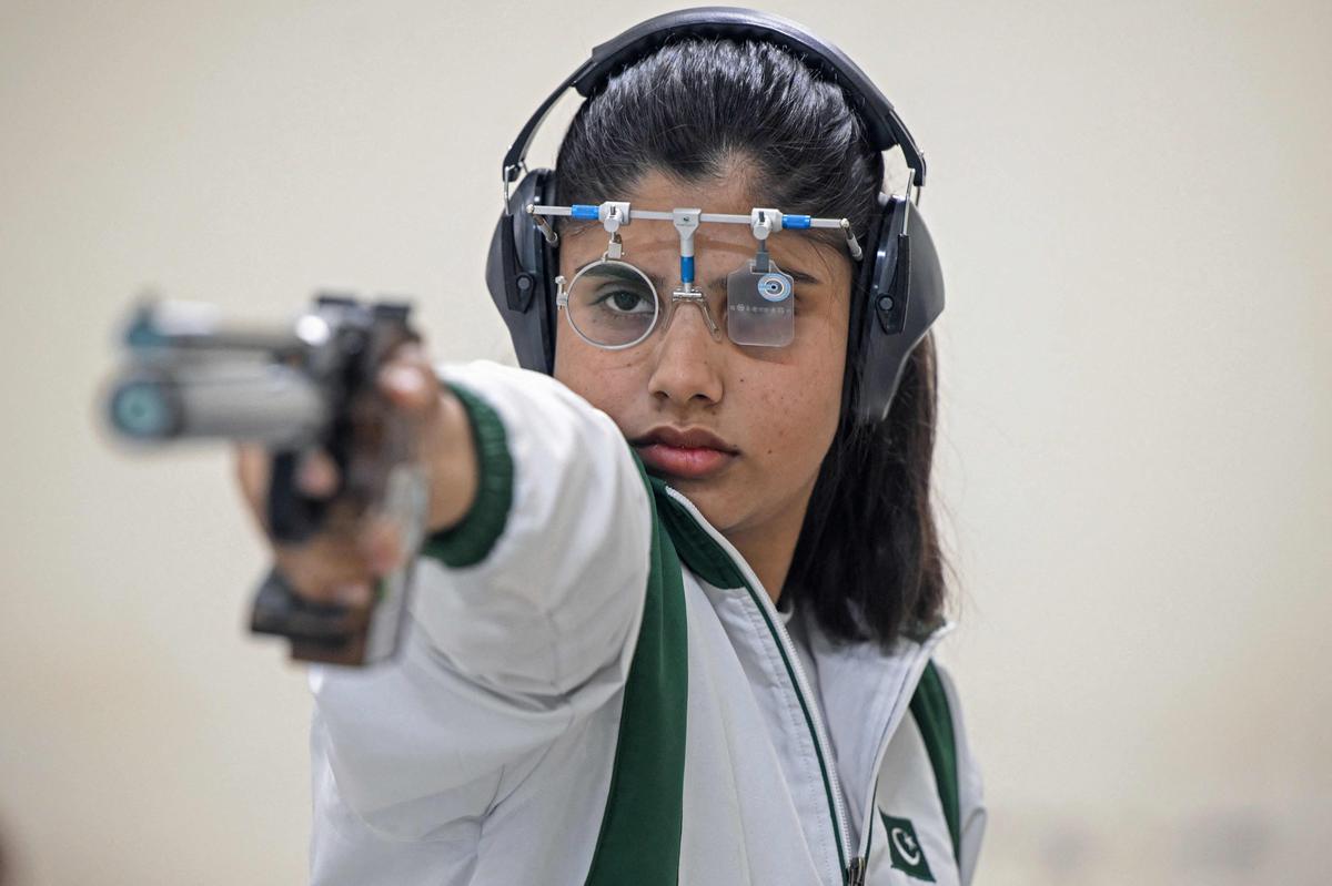 Kishmala Talat, Pakistan’s first female to qualify for Olympic shooting, aims an air pistol at a 10m target range during a practice session. 