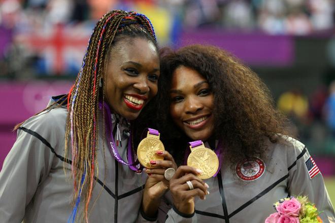 FILE PHOTO: Women’s doubles gold medalists Venus (left) and Serena Williams (right) at the 2012 London Olympics.  