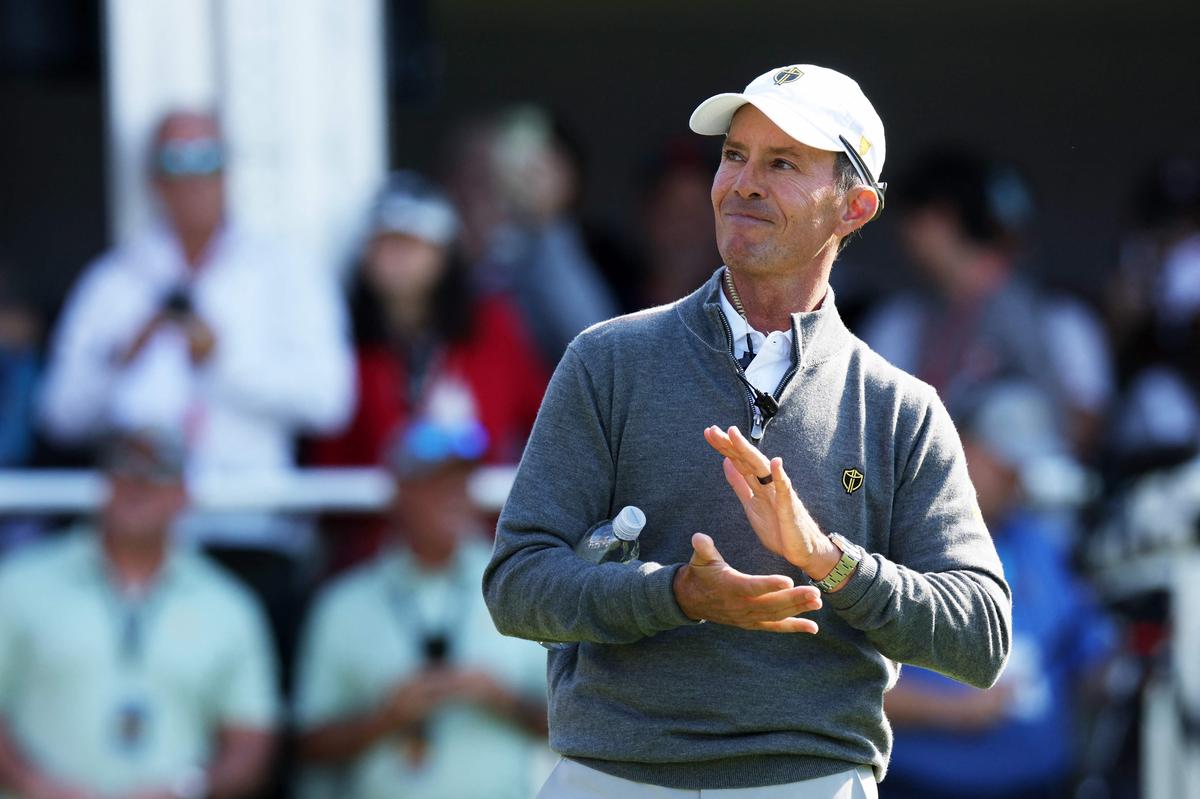 International Team Captain Mike Weir applauds on the first tee during Saturday Afternoon Foursomes on day three of the 2024 Presidents Cup.