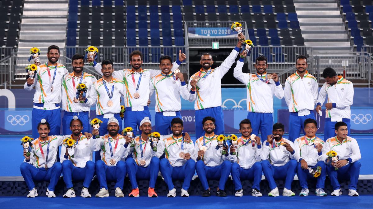  One for the album: The Indian hockey players pose with their bronze medals at the Tokyo Olympics. India beat Germany 5-4 in the third-place match to clinch a historic victory. Below: An ecstatic Sreejsh celebrates the win. 