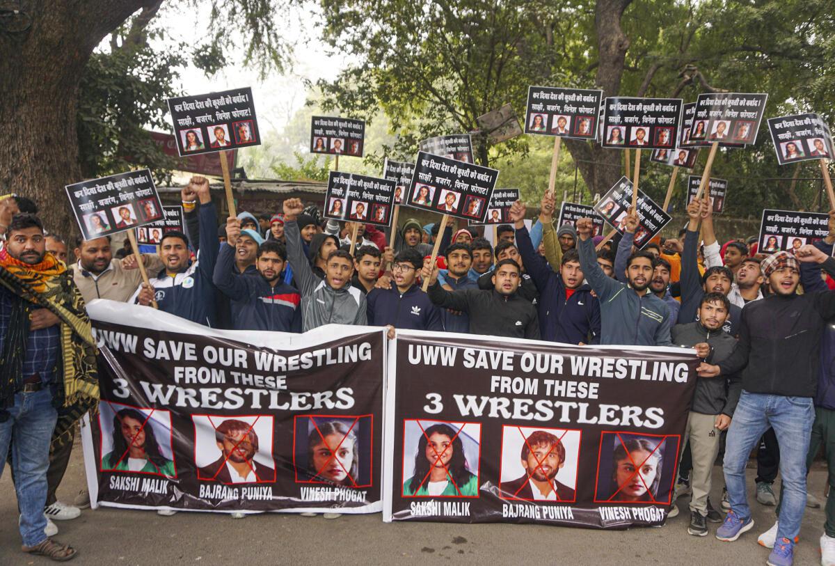 Young wrestlers hold placards during a protest against wrestlers Sakshi Malik, Bajrang Punia and Vinesh Phogat at Jantar Mantar in New Delhi on Wednesday.