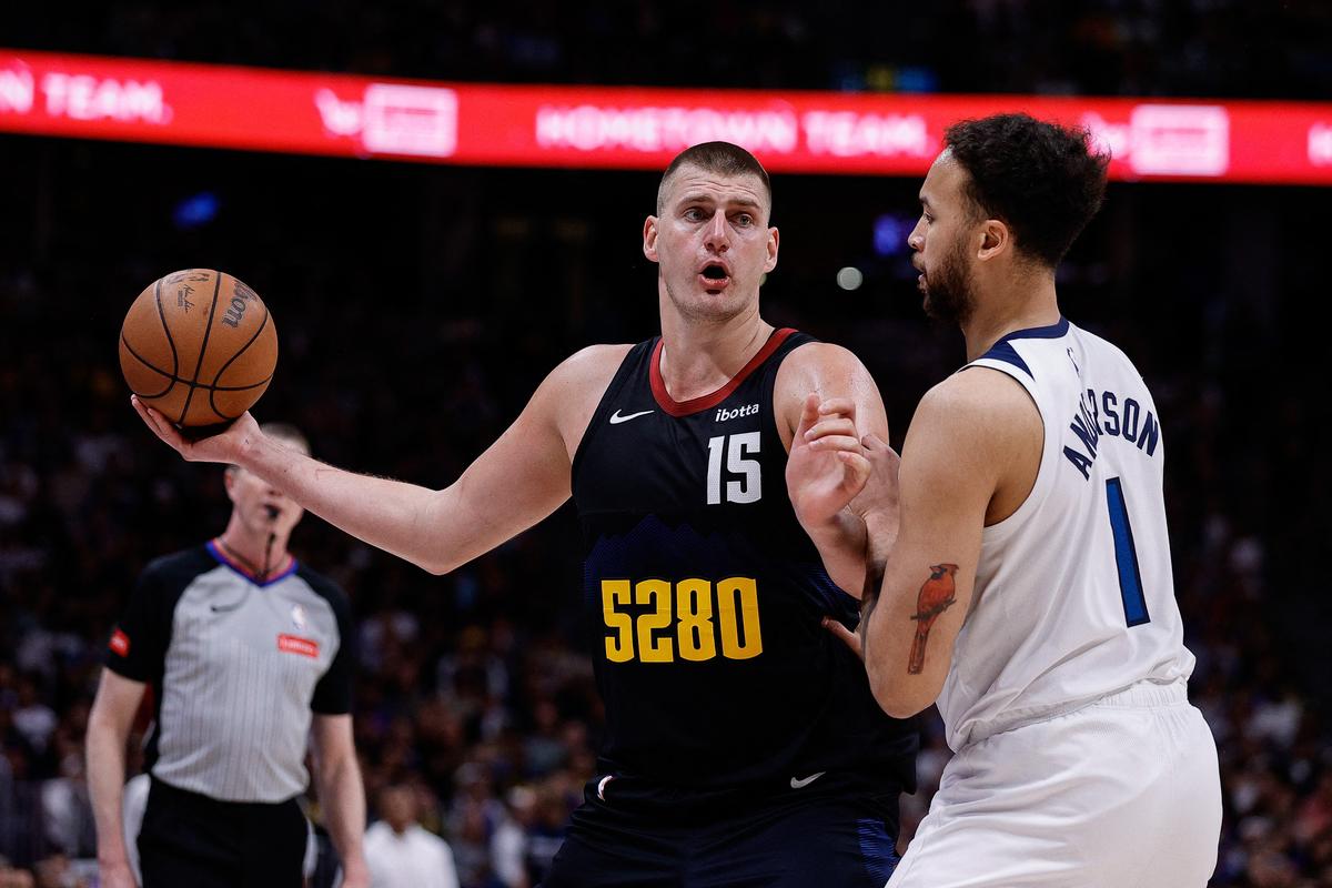  Denver Nuggets center Nikola Jokic (15) controls the ball as Minnesota Timberwolves forward Kyle Anderson (1) guards in the third quarter during game five of the second round for the 2024 NBA playoffs.