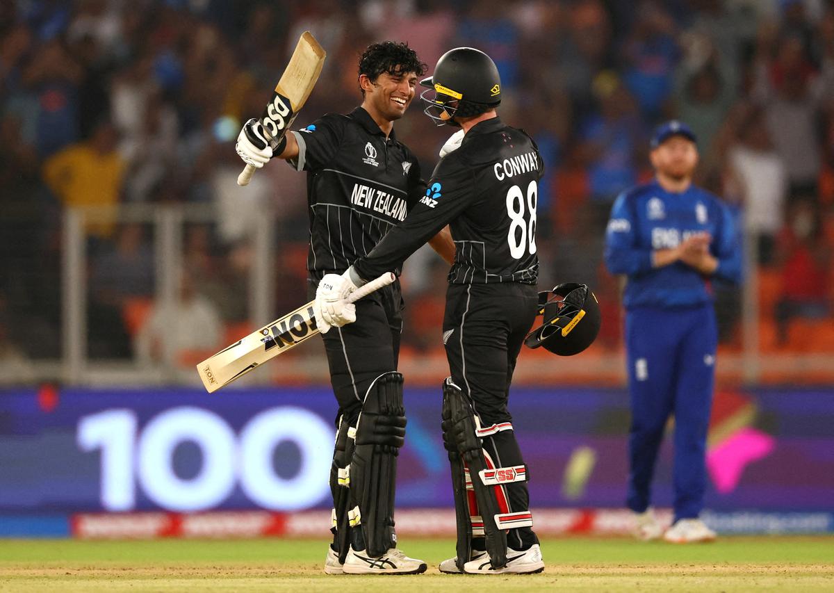 New Zealand’s Rachin Ravindra celebrates after reaching his century with Devon Conway, in the ICC Men’s ODI World Cup.