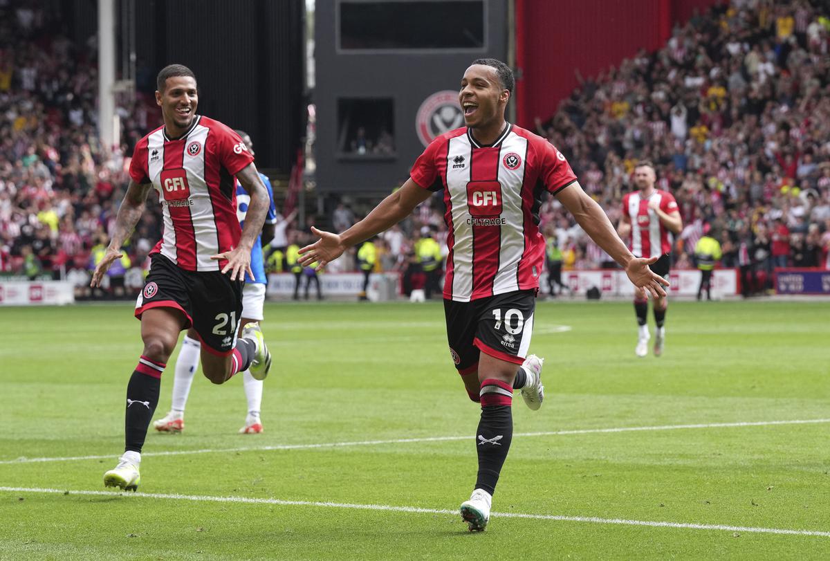 Sheffield United’s Cameron Archer, center, celebrates after his shot hits the post and rebounds off Everton goalkeeper Jordan Pickford to score its second goal during its English Premier League match at Bramall Lane, Sheffield.