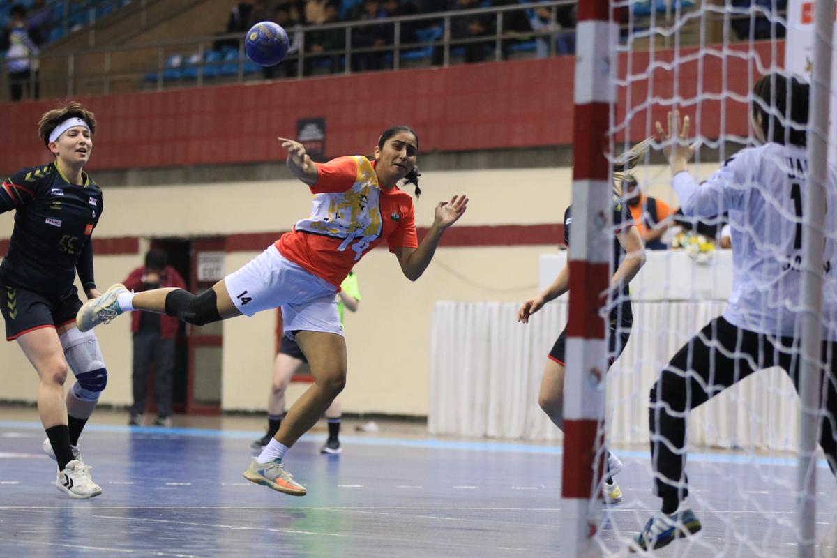 India’s Maninder Kaur (centre) attempts a shot at the Japanese goal during the Asian Women’s Handball Championship match in New Delhi on Friday.