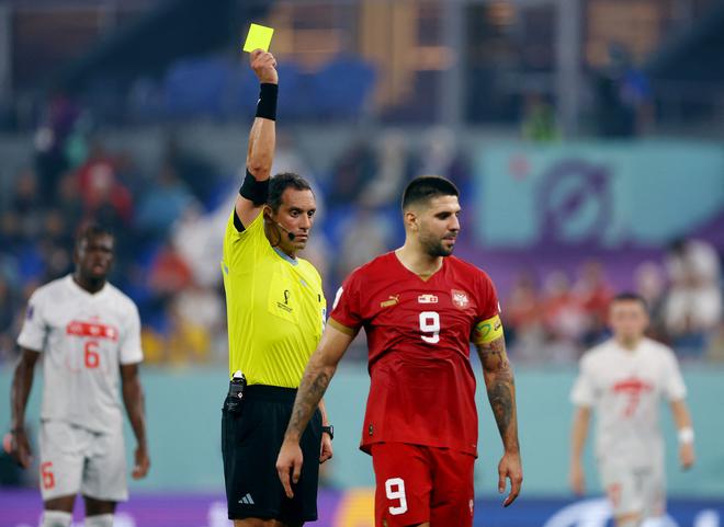 Serbia’s Aleksandar Mitrovic is shown a yellow card by referee Fernando Rapallini against Switzerland in the final group stage of the FIFA World Cup.