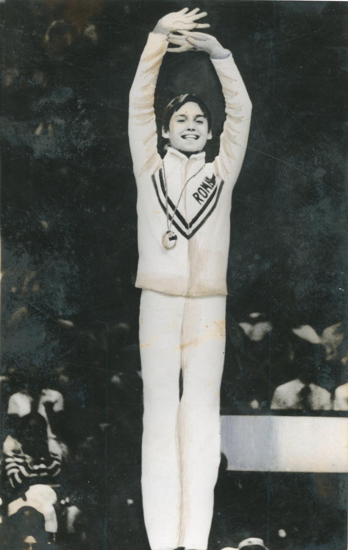 Romania’s 14-year-old Nadia Comaneci, with a gold medal swinging around her neck in the Montreal Olympic Games.