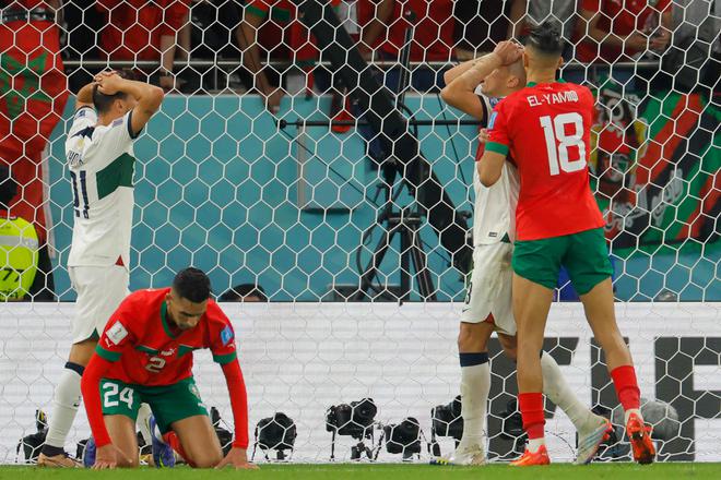 Jawad El Yamiq (R) kisses the head of Portugal’s Pepe after he missed the header.