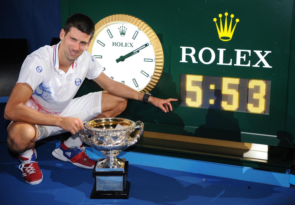 Djokovic poses for a photo with the clock showing the match time after beating Rafael Nadal in the 2012 final, the longest fixture in Australian Open’s history.