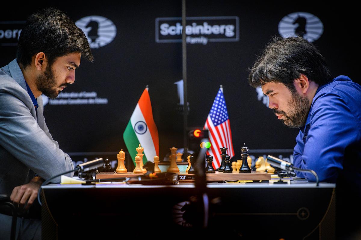 Grandmaster Gukesh playing against Hikaru Nakamura.