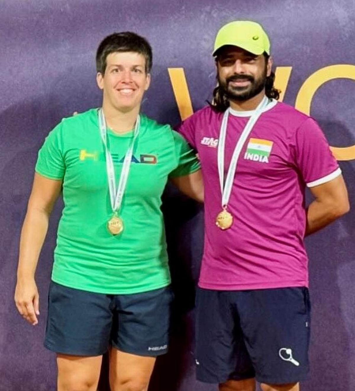 Kerstina Peckl and Chandril Sood with the mixed doubles gold in the ITF Masters tennis World Championship in Lisbon, Portugal. 