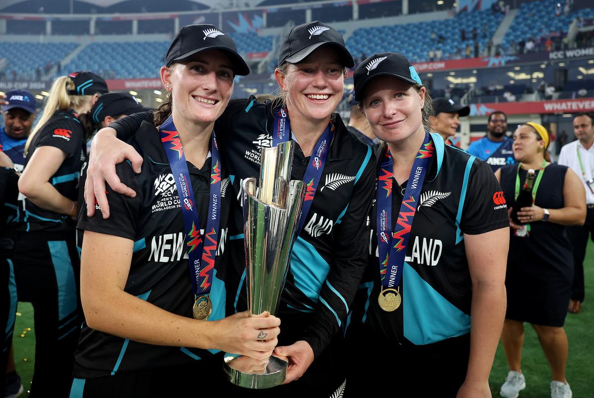 Rosemary Mair, Maddy Green and Brooke Halliday of New Zealand pose for a photo with the ICC Women’s T20 World Cup Trophy after defeating South Africa. 