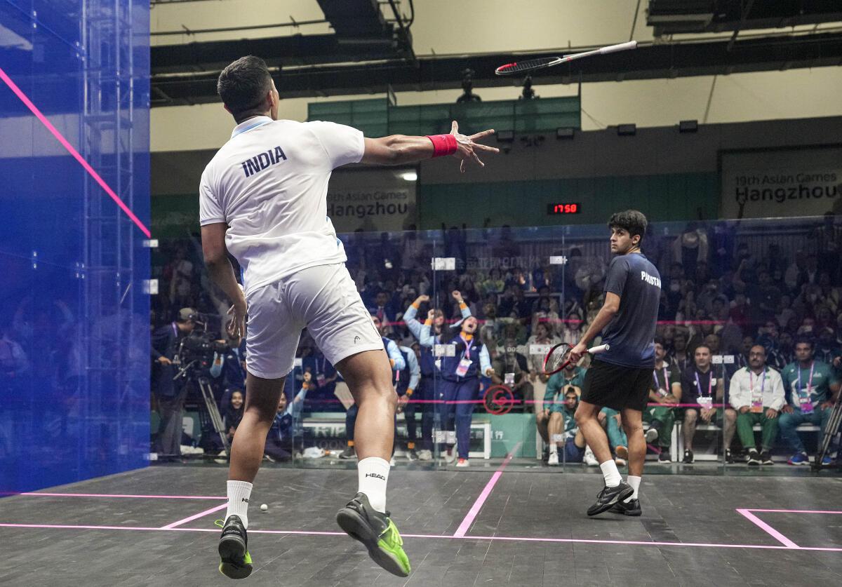 Singh is king: India’s Abhay Singh hurls his racquet into the stands after beating Pakistan’s Noor Zaman in the final of men’s team squash.