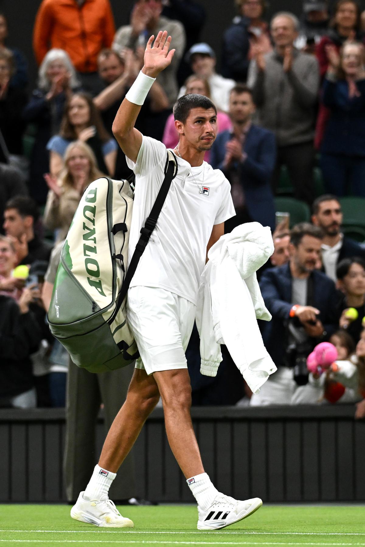 Australia’s Alexei Popyrin waves to the crowd as he walks off court after his defeat to Novak Djokovic. 