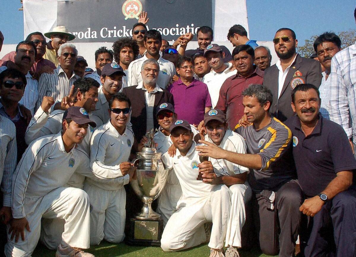 Members of the Rajasthan cricket team and Rajasthan Cricket Association President C.P. Joshi celebrate with the Ranji Trophy after beating Baroda in the final of the championship at Vadodara.