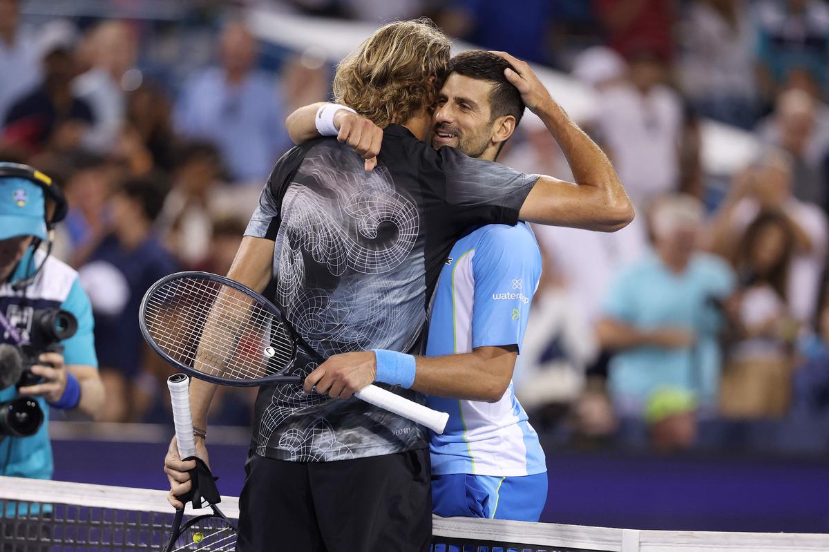 Alexander Zverev and Novak Djokovic meet at the net after their match. 