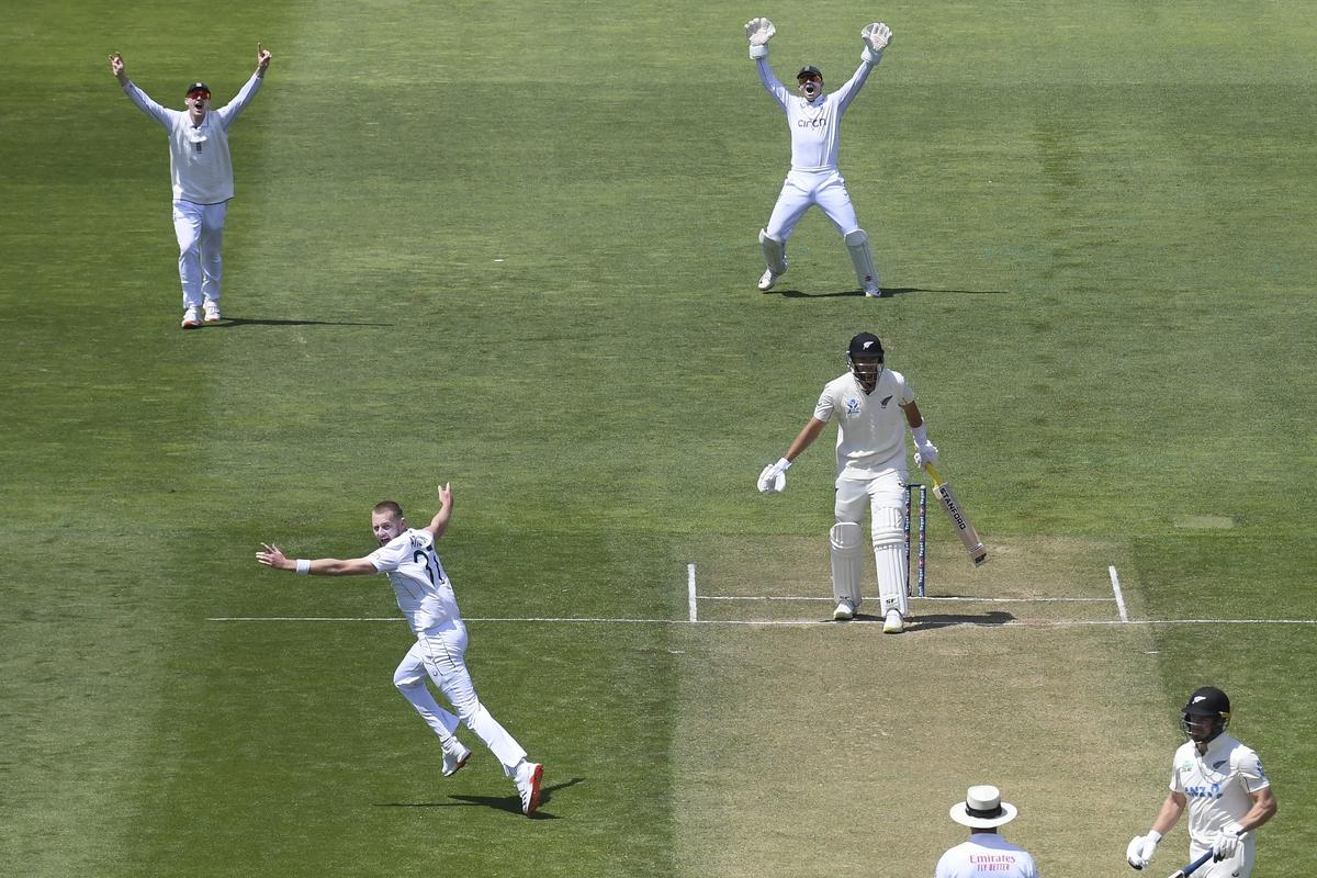 Gus Atkinson, bottom left, celebrates after scoring a hat-trick during day two of the second cricket test between New Zealand and England at the Basin Reserve in Wellington.